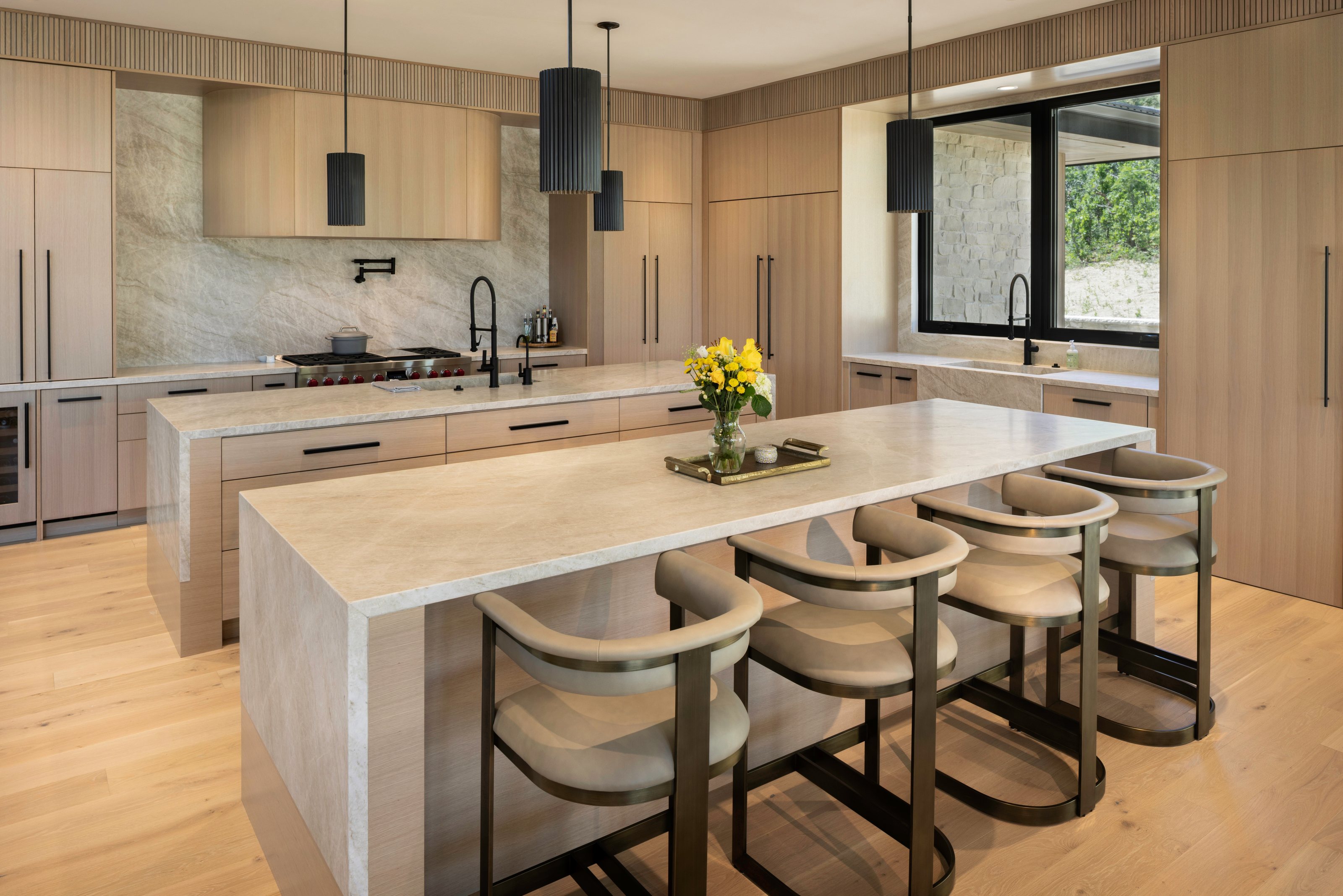 Light oak Affinity TruFrame® custom kitchen with waterfall marble islands